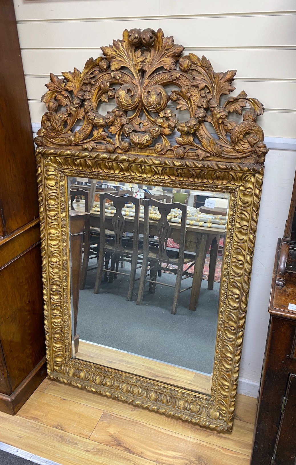 A 17th century style Italian design carved giltwood wall mirror, width 100cm, height 170cm